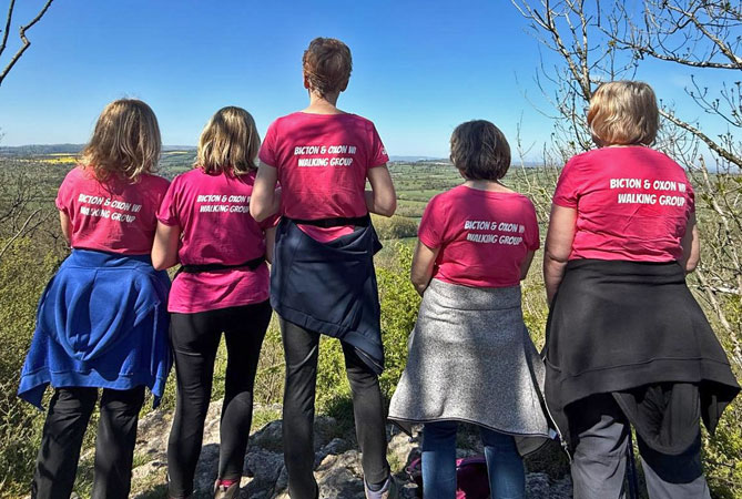 Five ladies in pink tshirts look at the view