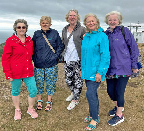 Five ladies stand on the Great Orme, wrapped up against the wind
