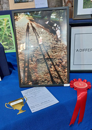 A photograph with red winning rosette