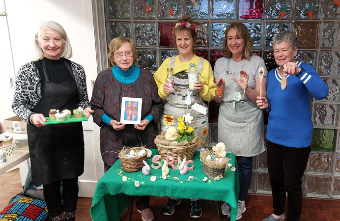 Five ladies pose with their crafts