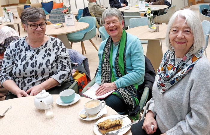 Three ladies have coffee and cake