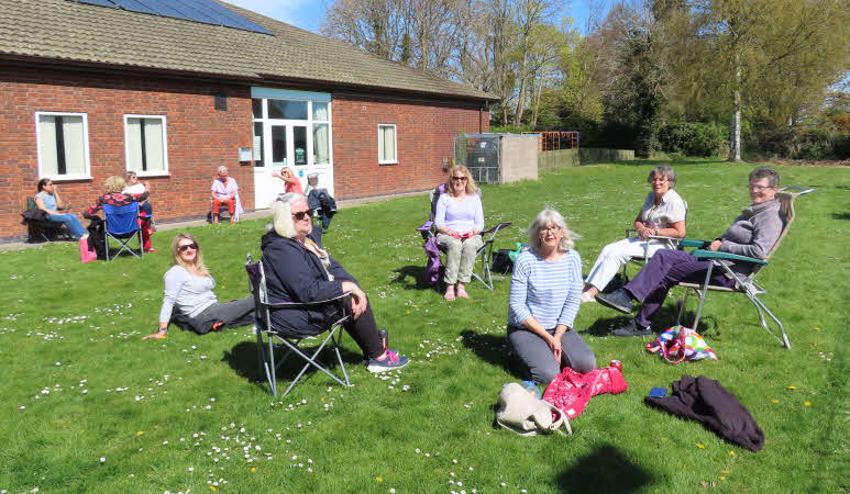 Twelve of our members enjoying our socially distanced Tea on the Field in the sunshine