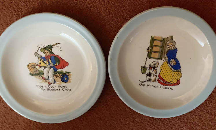 A picture of two children's plates featuring illustrated nursery rhymes